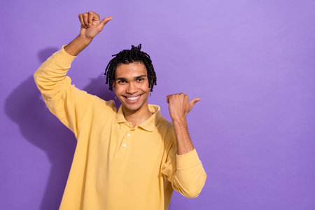 Photo of cheerful man wear trendy polo two arm above head demonstrate nice feedback empty space...