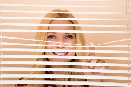 Portrait of positive entrepreneur lady finger open peek look through window shutter isolated on...