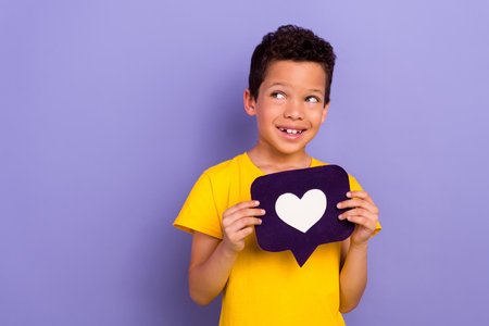 Photo of beautiful cute brunet hair boy wear stylish clothes hands showing paper card heart figure...