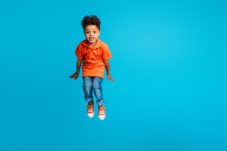 Full photo of jumping high trampoline funky schoolboy energetic overjoyed wear orange t shirt denim...