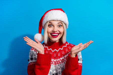 Portrait of astonished positive person toothy smile arms palms applaud newyear miracle isolated on blue color backgroundの写真素材