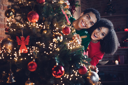 Photo of funny people friends from pine tree decorate for christmas event occasion with tinsels ornaments illumination indoorsの写真素材