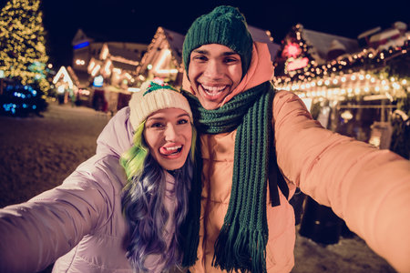 Photo of childish cool african guy lady dressed coats blogging recording video x-mas vlog together...
