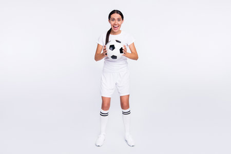 Full length photo of charming nice young woman amazed game hold ball hands isolated on grey color backgroundの写真素材
