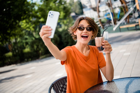 Photo of cheerful funky girl dressed stylish outfit having fun rest recording video live stream...