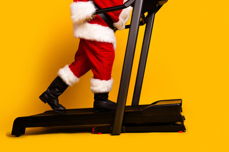 Profile side cropped photo of elderly man santa claus in traditional shoes going on treadmill...