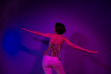 Back rear spine photo of carefree lady flying dance on new year christmas party isolated neon color backgroundの写真素材