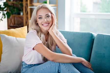 Photo of adorable gorgeous girl enjoying relax rest soft comfy sofa free time holiday morning at home indoorsの写真素材