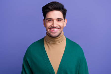 Photo of positive nice good mood man dressed green clothes isolated on purple color backgroundの写真素材