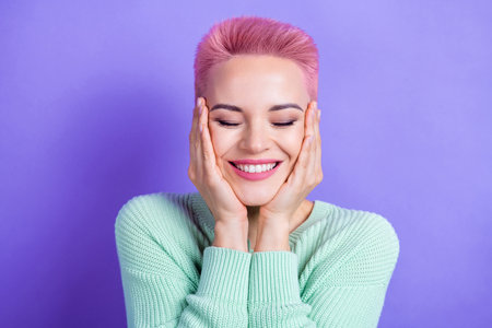 Photo of positive stunning lady arms touch cheekbones closed eyes beaming smile isolated on violet color backgroundの写真素材