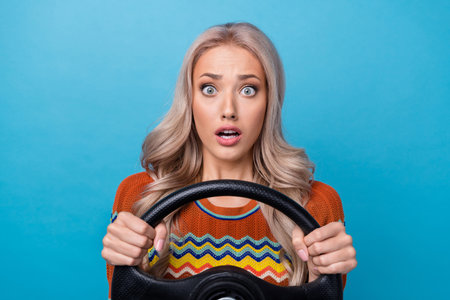 Photo of pretty shocked lady wear print shirt driving car stuck in traffic jam isolated blue color backgroundの写真素材