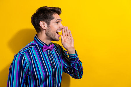 Portrait of cheerful funky guy dressed shirt bow tie announcing big sale look empty space isolated...