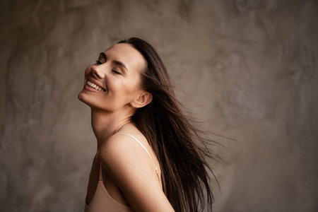 Photo of stunning tender lady closed eyes without filters enjoying naturality pure perfect skin isolated on grey concrete wall backgroundの写真素材