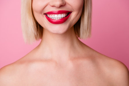 Cropped photo of cheerful good mood girl naked shoulders smiling showing white teeth isolated pink color backgroundの写真素材