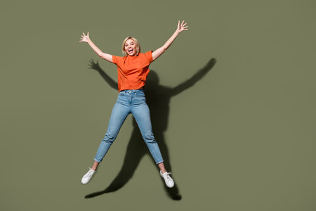 Full length size photo of crazy girl active person jumping trampoline raised hands up star symbol...