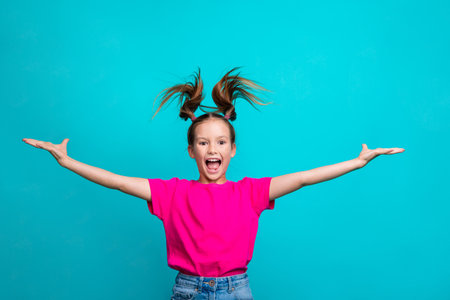 Photo of adorable cheerful nice girl dressed pink t-shirt palms presenting product empty space isolated on turquoise color backgroundの写真素材