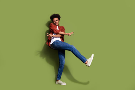 Full size photo of handsome young guy cheerful dancing have fun dressed stylish brown outfit...