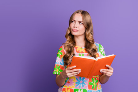 Portrait of intelligent smart girl dressed print t-shirt reading book look at offer empty space...