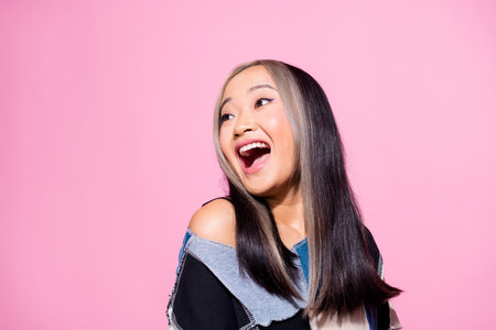 Photo of pretty astonished girl open mouth look empty space ad news isolated on pink color backgroundの写真素材