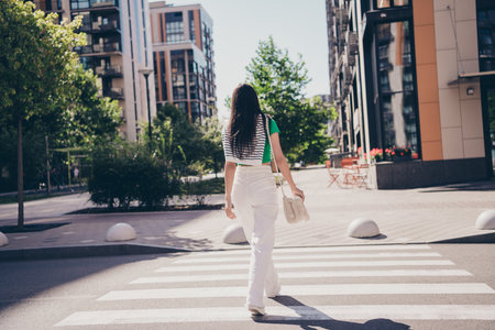 Full length body view photo of steps brunette hair woman crosswalk city streets traveling on fresh air outdoors outside residential complexの写真素材
