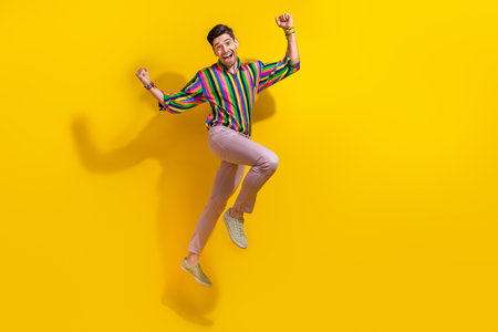 Full body photo of young boyfriend wearing stylish vintage old school garment raised fists up...