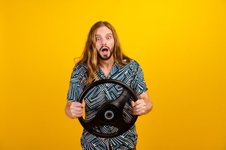 Photo of excited funky man dressed print shirt driving auto open mouth isolated yellow color...