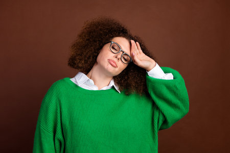 Portrait of corporate manager lady arm touch forehead feel sick ill headache isolated on brown color backgroundの写真素材