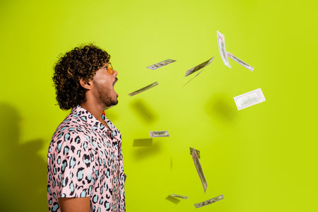 Photo portrait of handsome young guy catch mouth banknotes dressed stylish pink leopard print outfit...