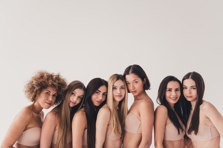 No filter photo of gentle tender multinational girls demonstrate concept every body is beautiful isolated pastel color backgroundの写真素材