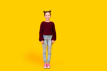 Full length portrait of charming positive person stand posing empty space ad isolated on yellow color backgroundの写真素材