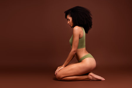 Profile side photo of charming stunning no filter body advertise fashion khaki lingerie top panties isolated brown color backgroundの写真素材