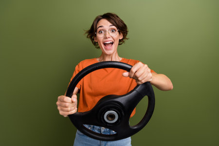 Photo of crazy woman holding leather steering wheel turns left road trip new ownership automobile...