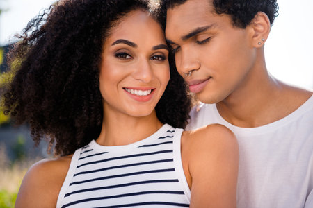 Photo of charming couple lady guy cuddle feeling affectionate loving care on summer town vacation outdoorsの写真素材