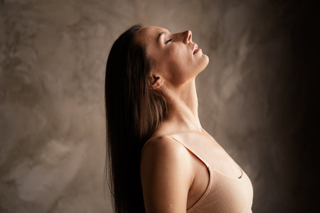 Profile side photo of lovely lady long hair natural care products nourishment procedure no filter isolated on grey concrete wall backgroundの写真素材