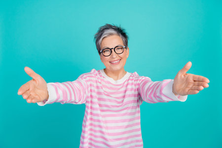 Photo of sweet shiny woman dressed pink pullover eyewear open arms ready hug you isolated teal color backgroundの写真素材