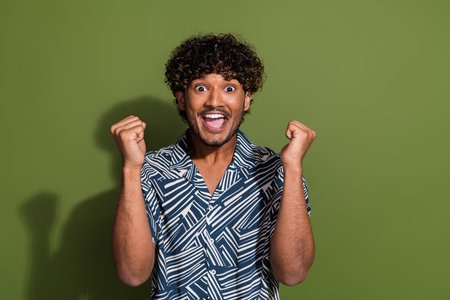 Portrait of awesome winner guy with wavy hair indian fan support his national football team match...