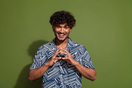 Photo of young minded tricky mexican wavy hair guy in shirt find decision how cheat his girlfriend isolated over khaki color backgroundの写真素材