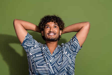 Photo of young cheerful hispanic man in stylish shirt take nap look up and dreaming about his...