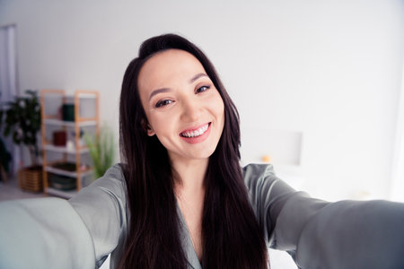 Photo portrait of lovely young lady toothy smile take selfie photo dressed stylish gray sleepwear...
