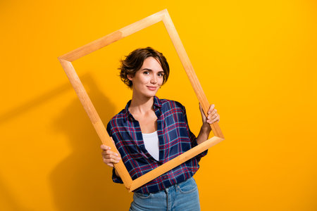 Photo of gorgeous adorable woman with bob hair dressed plaid shirt posing in wood picture frame...