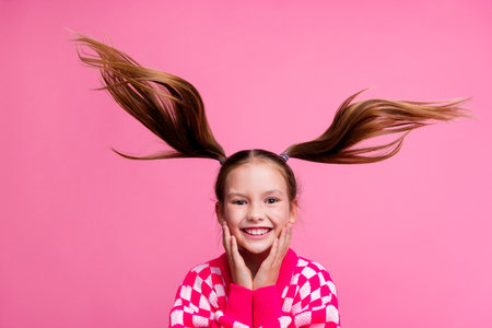 Photo of cute adorable cheerful girl in trendy clothes touch face have fun rejoice special sale discount isolated on pink color backgroundの写真素材