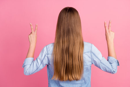 Photo portrait of lovely young lady posing show length haircut show okey sign wear trendy jeans garment isolated on pink color backgroundの写真素材
