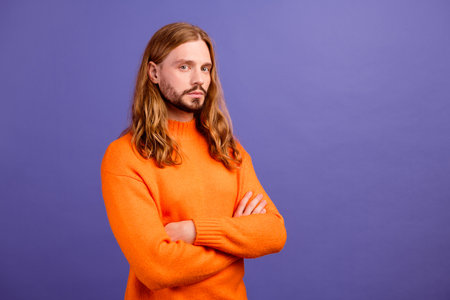 Closeup photo of young hipster blond man seems serious and experienced office manager folded hands isolated on violet color backgroundの写真素材
