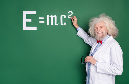 Photo of happy charming cheerful professor write chalk board equation lecture isolated on green color backgroundの写真素材