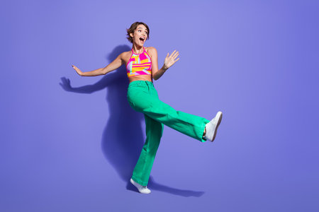 Full length photo of overjoyed lovely girl wear bright outfit celebrate festive event look empty...