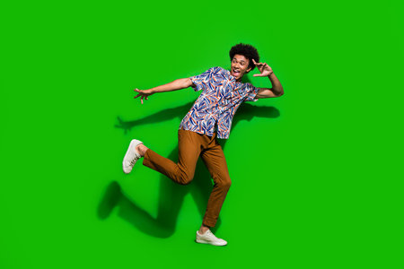 Full length photo of young man dancing have fun good vibe and discotheque atmosphere listening music...