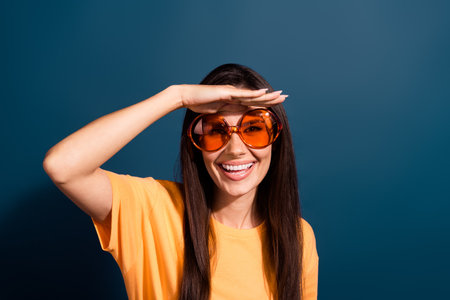 Portrait of toothy beaming woman wear stylish t-shirt in sunglass hold palm on forehead watch...