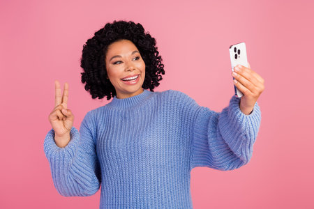 Photo portrait of pretty young girl take selfie show v-sign video call wear trendy blue knitted...
