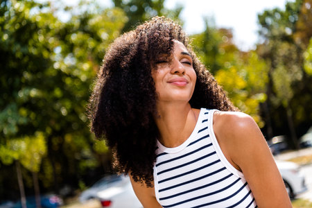 Photo of cheerful optimistic adorable shiny girl having fun enjoying green spring season springtime...
