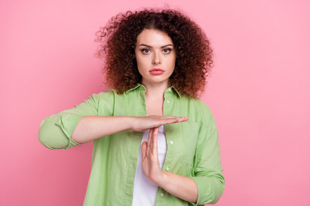 Photo portrait of attractive young woman show time out gesture dressed stylish green clothes...
